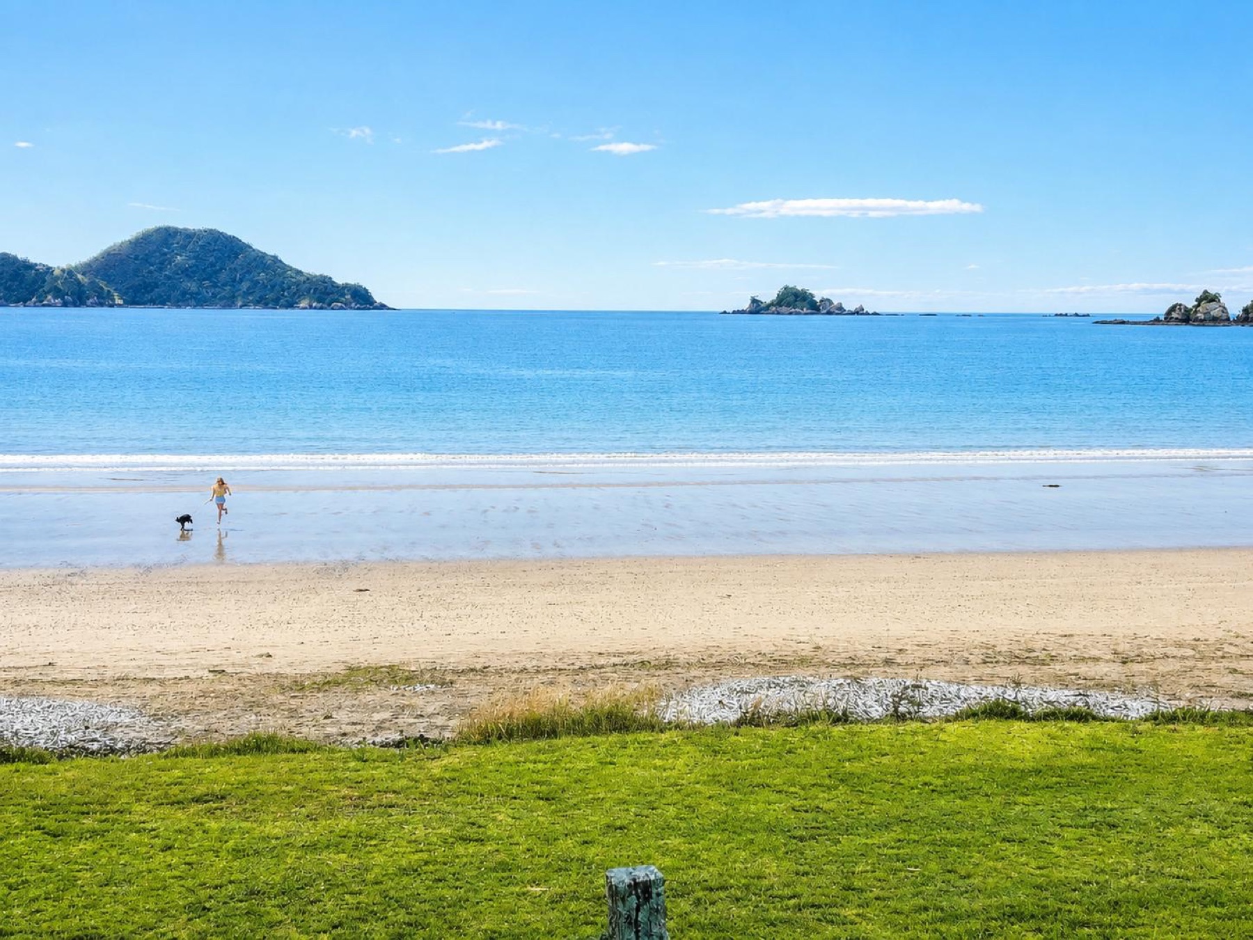 The curve of the sand at Oakura Bay