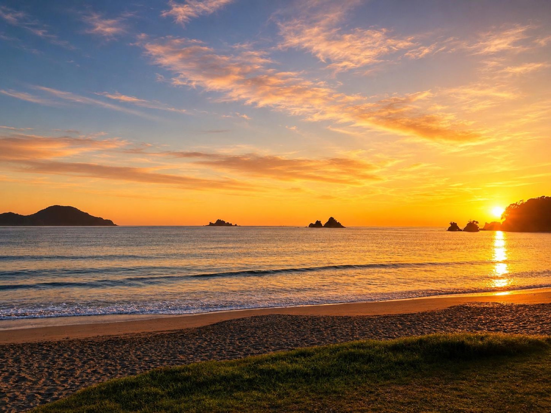 Orange sunrise over Oakura Bay