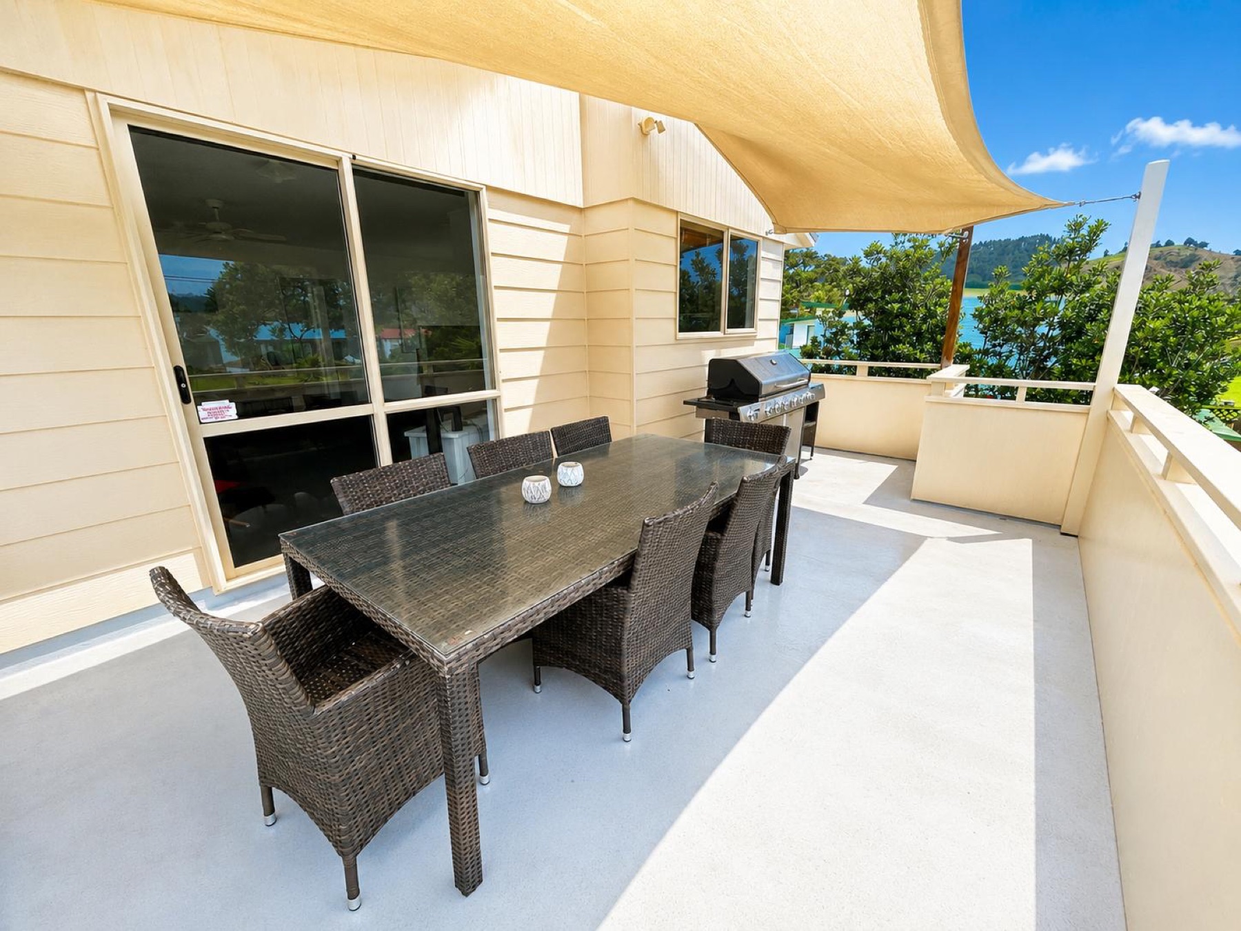 Covered upper deck with dining table and barbecue